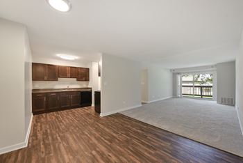 Open concept living area with kitchen and hardwood flooring
